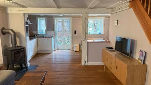a living room with a television and a stove at Ferienhaus St. Johannis in Werben