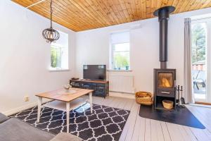 a living room with a wood stove and a table at VAR950-Hagfors-Knoaende-13 in Hagfors