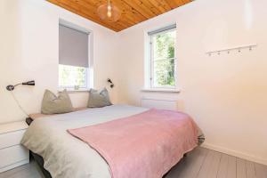 a bedroom with a bed and two windows at VAR950-Hagfors-Knoaende-13 in Hagfors