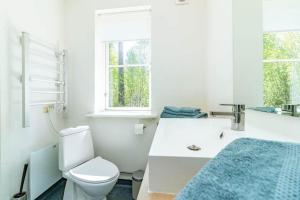 a white bathroom with a toilet and a sink at VAR950-Hagfors-Knoaende-13 in Hagfors +16 photos