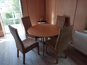a wooden table and chairs with a table and a window at Wohnung in Waldnähe in Waltershausen