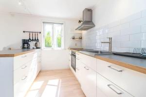 a kitchen with white cabinets and a sink at VAR949-Hagfors-Knoaende-11 in Hagfors