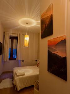 a bedroom with a bed and a painting on the wall at Centro Storico Suites Sarnico in Sarnico +38 photos