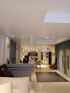 a large living room with a couch and a living room at Viasui Hotel in Buenos Aires