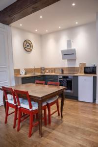 a kitchen with a wooden table and four chairs at 2 Chambres, Les Dentellières de la Cathédrale in Troyes +13 photos