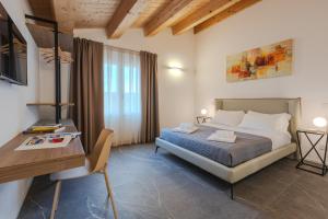 a bedroom with a bed and a table and a desk at Villa Alice in Montecosaro +36 photos