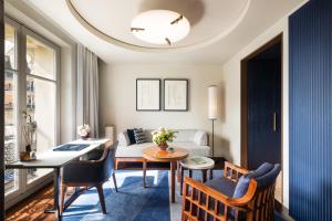 a living room with a table and chairs and a couch at Mandarin Oriental Lutetia, Paris in Paris +167 photos