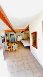 a room with a table and chairs and a bed at Quadruple Room 3629 in St. Paul's Bay