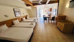 a hotel room with two beds and a dining room at Quadruple Room 3629 in St. Paul's Bay