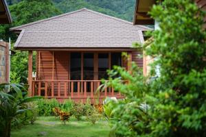 a log cabin with a porch and a deck at PingChan Koh Phangan Beachfront Resort in Thong Nai Pan Yai