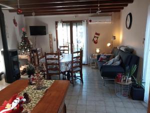 a living room with a table and a christmas tree at La Cabane du Berger & son terrain de pétanque in Torsiac