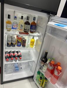 an open refrigerator full of drinks and drinks at Apartamentos con aire acondicionado SAN LUIS in San Luis