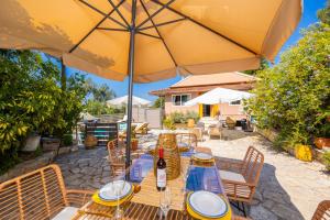 a table with an umbrella on a patio at Dimitris Cottage in Apergátika +34 photos