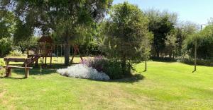 a park with a playground and a swing set at Casa Dique Cabra Corral in Coronel Moldes