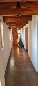 an empty hallway with a wooden ceiling in a building at Casa Dique Cabra Corral in Coronel Moldes