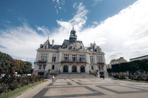 a large white building with a sky in the background at Douceur de Vivre à Vichy, T1B, Cosy& Lumineux, 4p in Vichy