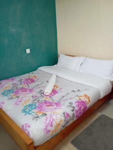 a bedroom with a bed with a flower patterned blanket at Longonot View Camp and Accommodation, Naivasha in Naivasha +38 photos