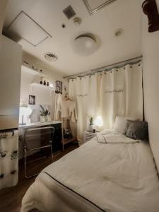 a bedroom with a bed and a vanity and a sink at Bomnal Stay 봄날스테이 in Samgong