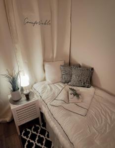 a small bed in a small room with a table at Bomnal Stay 봄날스테이 in Samgong