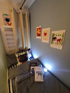 a small bedroom with a bed with lights on it at Bomnal Stay 봄날스테이 in Samgong