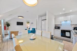 a dining room and kitchen with a table and chairs at 5 Rushbrooke Hotel Apartments Cobh County Cork in Cobh +14 photos