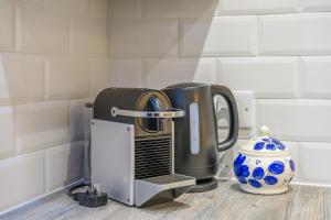 a toaster sitting on a counter next to a vase at 5 Rushbrooke Hotel Apartments Cobh County Cork in Cobh