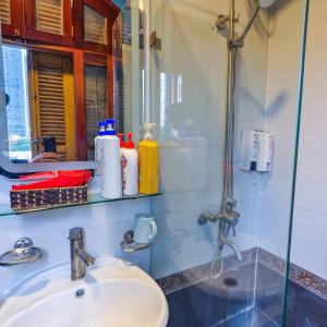 a bathroom with a sink and a mirror at Xumi Motel in Hanoi