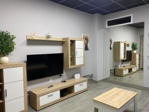 a living room with a flat screen tv on a wall at Miamar in Seville