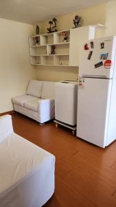 a living room with a refrigerator and a couch at Plaza murillo in La Paz