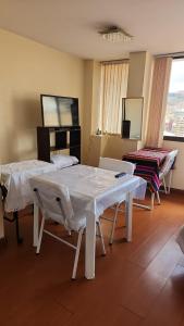a hospital room with two beds and a table at Plaza murillo in La Paz