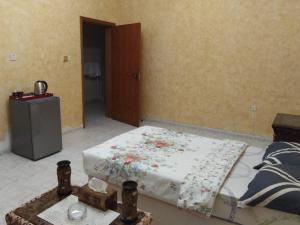 Giường trong phòng chung tại DIAMANTE Al Ain