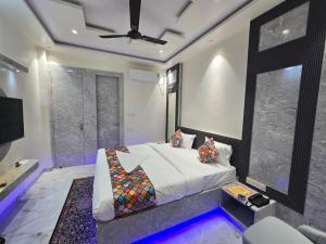 a bedroom with a king sized bed and a tv at HOTEL REAL Inn in Muzaffarpur