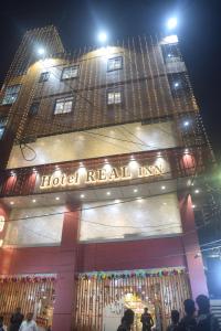 a hotel real inn is lit up at night at HOTEL REAL Inn in Muzaffarpur