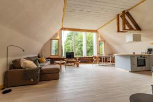 a living room with a couch and a table at KRO845-Lessebo-Vedamala-14 in Ljuder