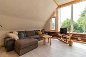 a living room with a couch and a tv at KRO845-Lessebo-Vedamala-14 in Ljuder