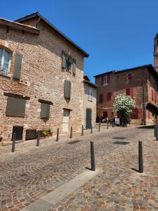 a cobblestone street in front of a brick building at Le petit marché de Sainte Cécile- Centre historique Albi in Albi