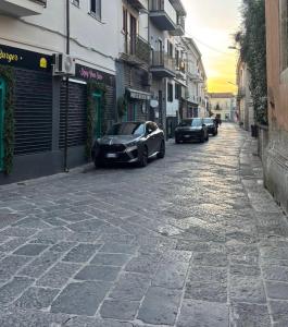 a street with two cars parked on the street at 50 Passi dal Duomo in Marcianise