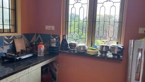 a kitchen with a counter with pots and pans at Pk Villa in Auroville +37 photos