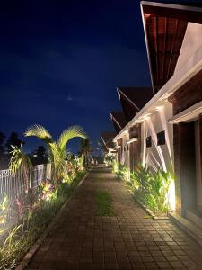 a walkway next to a building at night at Svadarma Bali Villa in Darmasaba