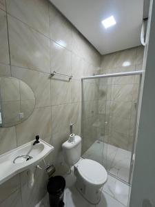 a bathroom with a toilet and a sink and a shower at pousada palmeiras bhs in Barreirinhas