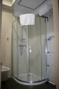 a shower with a glass door in a bathroom at Park Apartments in Izola