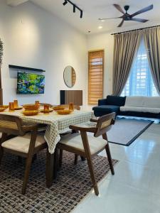 a living room with a table and a couch at Che Nat Che Nor Homestay in Kuala Terengganu +28 photos