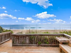 a wooden deck with a bench and the beach at 1222 - Asher in Corolla