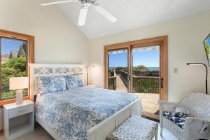 a bedroom with a bed and a balcony at 1222 - Asher in Corolla