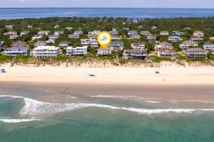 an aerial view of a beach with a yellow kite at 1222 - Asher in Corolla