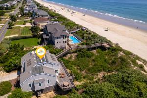 an aerial view of a house next to the beach at 1222 - Asher in Corolla