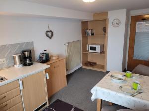 a kitchen with a table and a counter top at Haus Steinacher in Hopferau