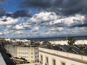 a view of a city under a cloudy sky at Pension Gibraltar in Tangier