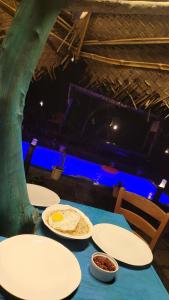 a blue table with plates of food on it at Sky Blue Cabin in Kandy