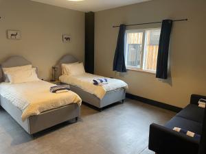 a room with two beds and a window at Spring Meadow in Durham